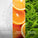 Three vertical panels showing cosmetic ingredients and their benefits: left panel with clear gel and bubbles labelled 'Plant Polymers – Hold Makeup in Place'; centre panel with close-up of sliced oranges labelled 'Vitamin C – Brightens & Evens'; right panel with green seaweed labelled 'Desert Algae – Hydrates & Plumps'.
